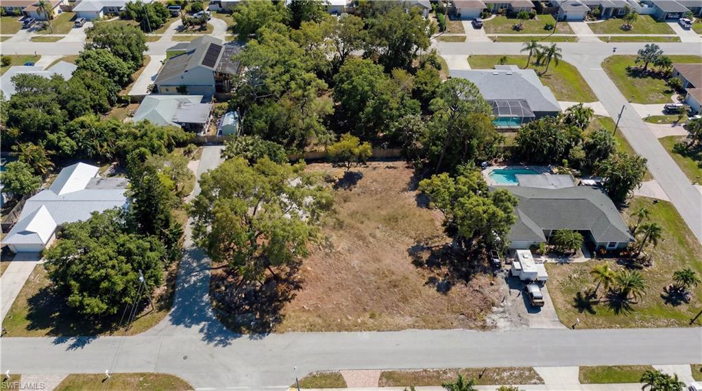 Image 2: Aerial view of property and surrounding area with nearby suburban area