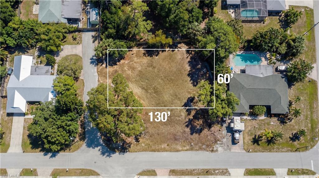 Image 3: Aerial view of property and surrounding area featuring property boundaries highlighted and a pool area