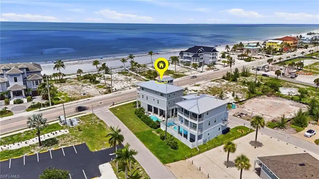 Image 1: Multi-story coastal residence featuring a flat roof and multiple balconies - Virtually Edited Image