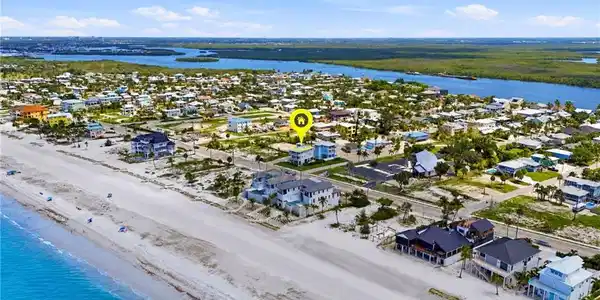 Image 3: Aerial perspective showcasing a coastal community with direct beach access - Virtually Edited Image