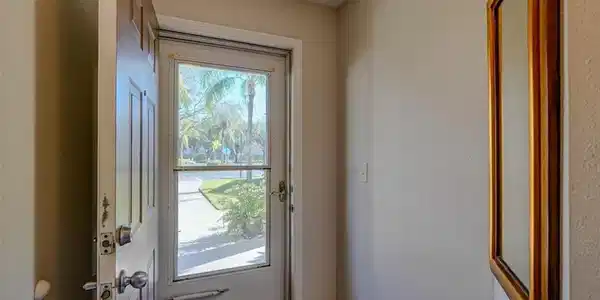 Image 2: Doorway featuring baseboards and tile patterned flooring