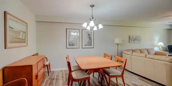 Image 4: Dining room with wood finished floors and a chandelier