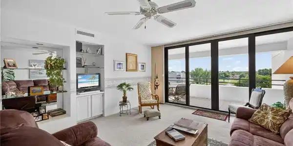 Image 2: Living room with Hurricane Impact Sliders onto Spacious Balcony