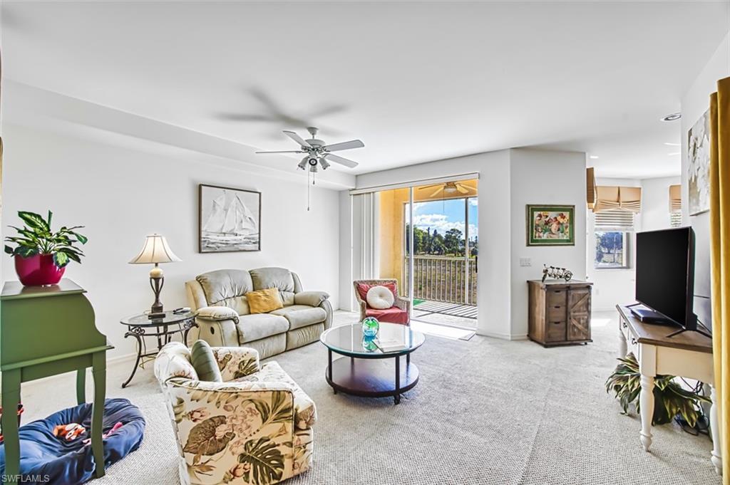 Image 3: Living area with carpet and ceiling fan