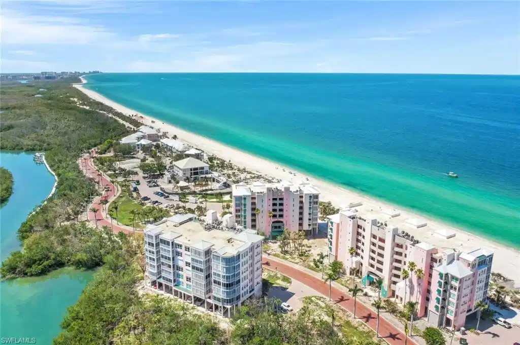 Image 1: Drone / aerial view of apartment complex / building and waterfront with a beach