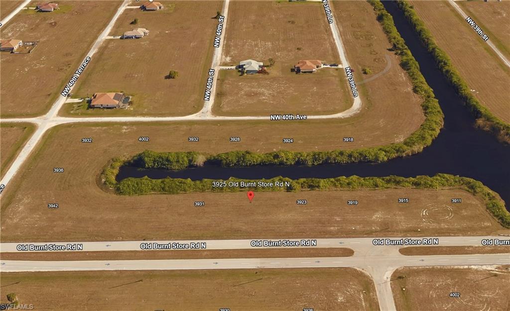 Image 1: Aerial view of residential area with a large body of water