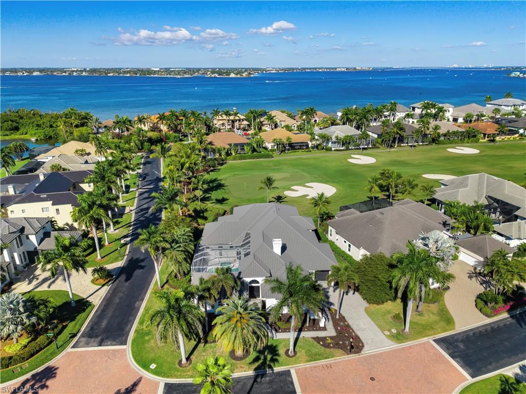 Image 1: Aerial view of residential area with a large body of water and a golf club