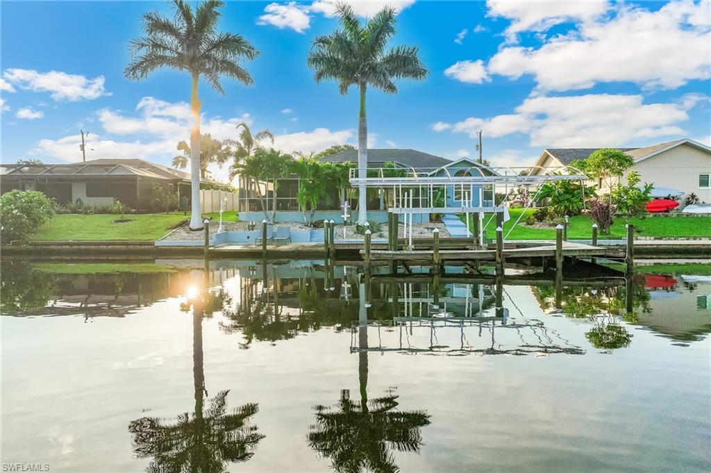 Image 3: Dock with a water view, boat lift, and a residential view