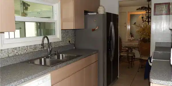 Image 4: Kitchen featuring light cabinets, dishwasher, stainless steel refrigerator with ice dispenser, range with electric stovetop, and light tile patterned floors