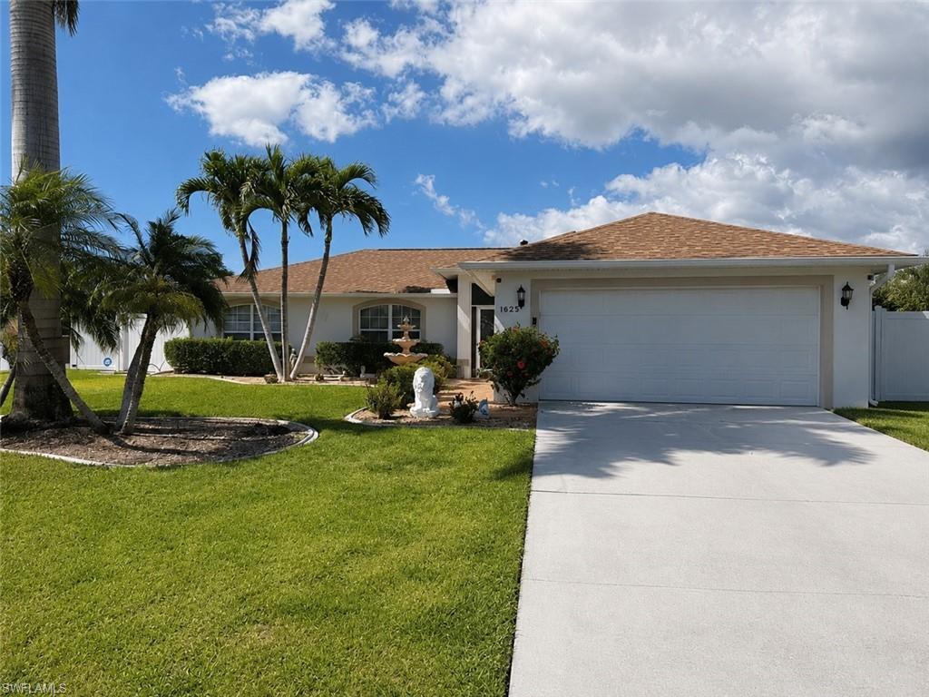 Image 2: Single-story residence featuring a two-car garage, concrete driveway, and a shingle roof