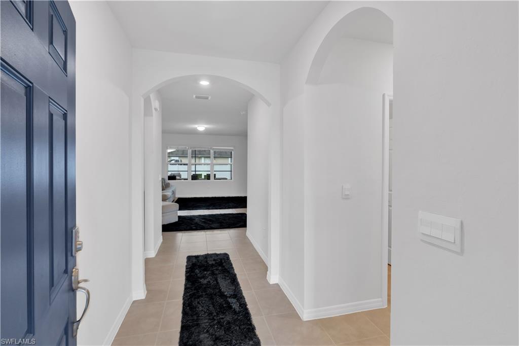 Image 4: Hall with arched walkways and light tile patterned flooring
