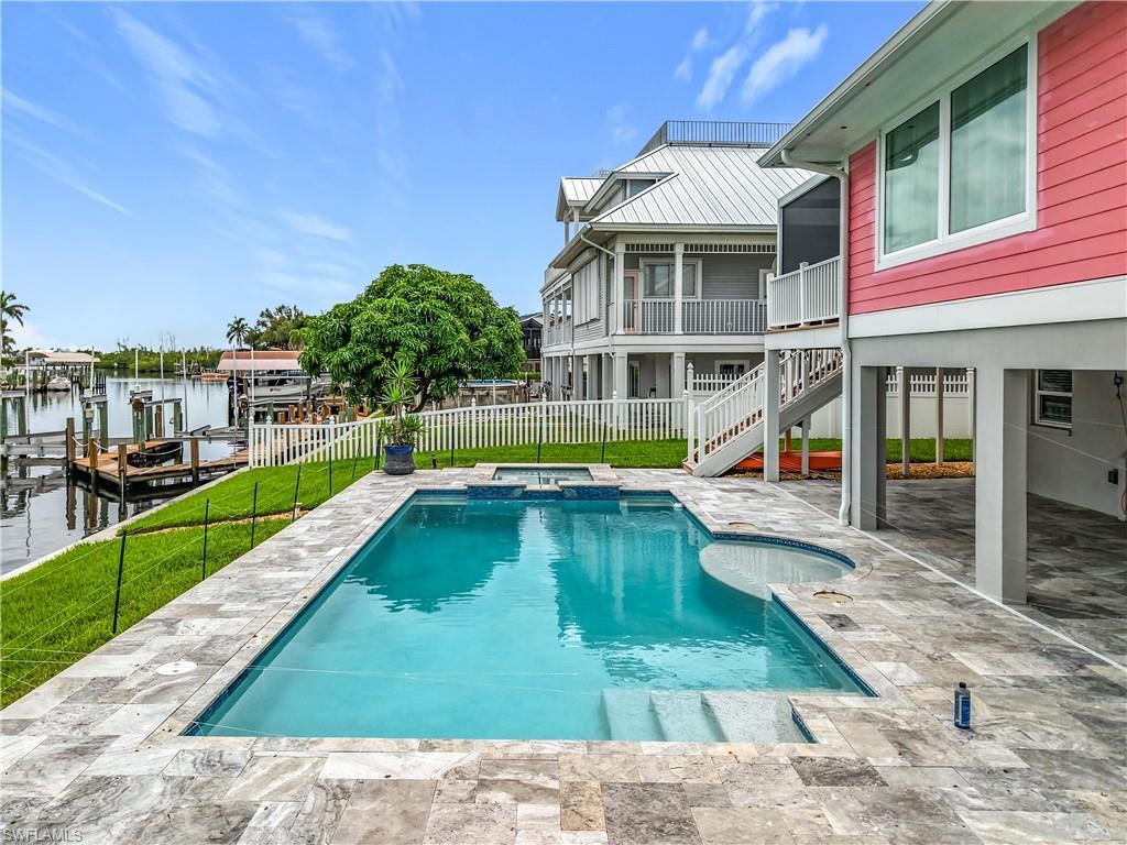 Image 4: Pool and spa. Decorative travertine decking.