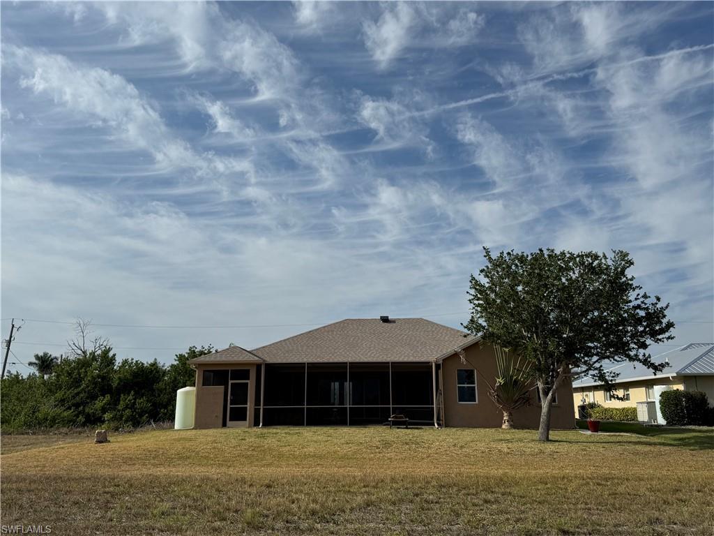 Image 4: Mediterranean / spanish house with an attached garage, fence, a front yard, and stucco siding