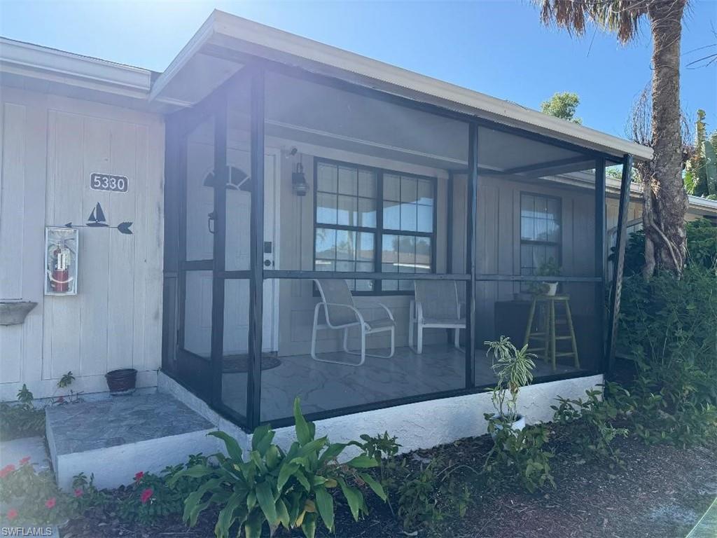 Image 1: Doorway to property with a screened cvd lanai