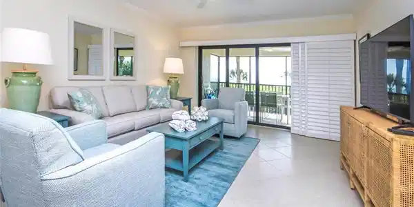 Image 2: Living area with crown molding, light tile patterned floors, and ceiling fan