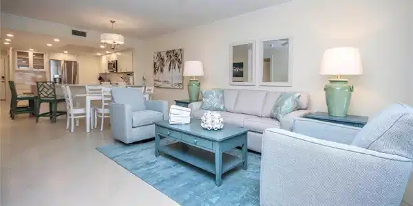 Image 3: Living area featuring crown molding, light tile patterned flooring, and a ceiling fan