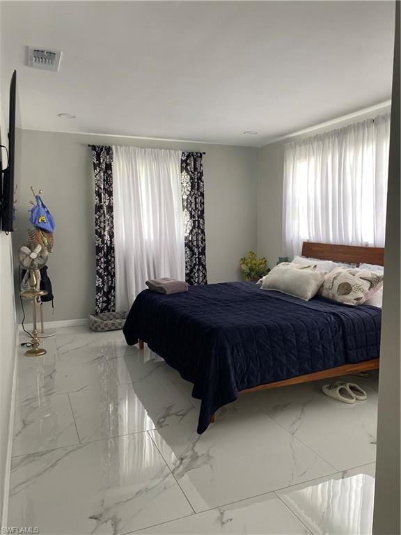 Image 4: Bedroom with marble finish floors and baseboards