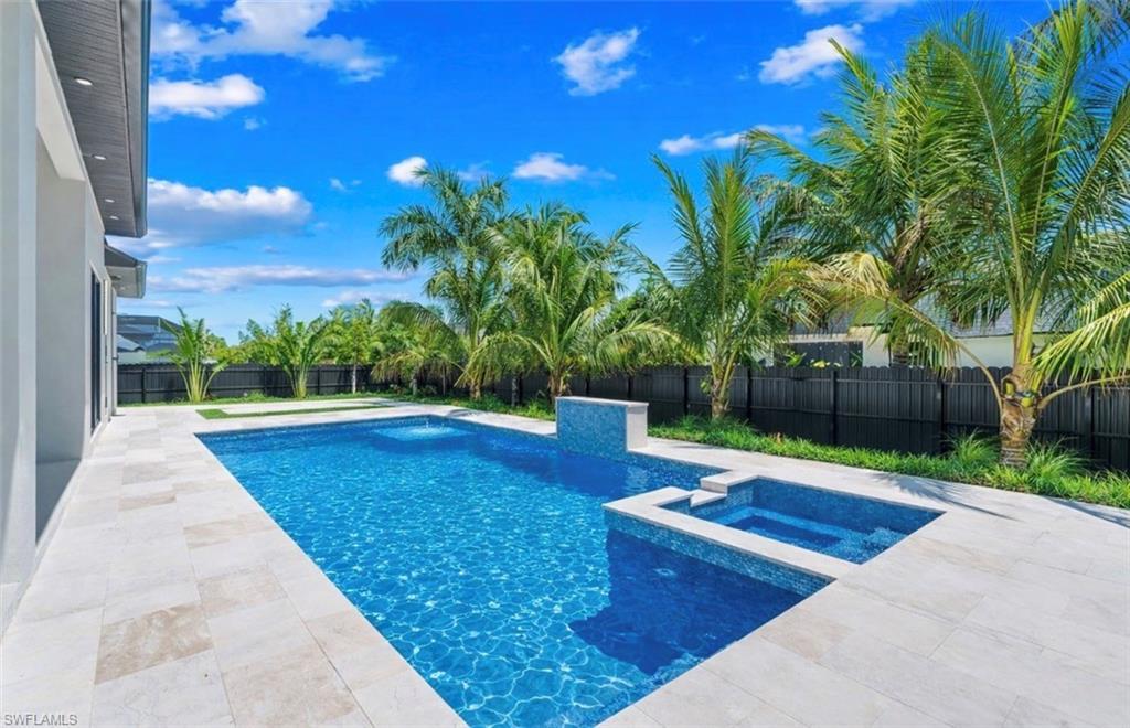 Image 3: Relaxing pool / spa with a patio area and a fenced backyard