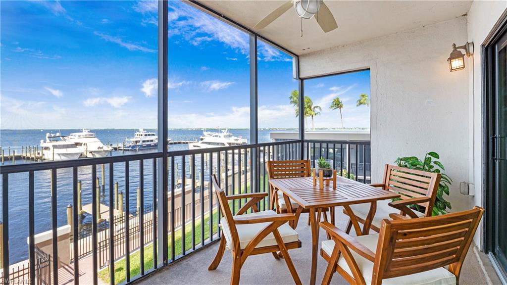 Image 1: Sunroom featuring floor to ceiling windows, a water view, and carpet floors