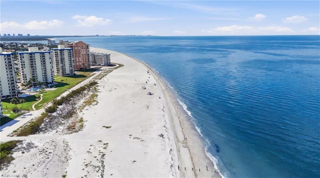 Image 1: Expansive beachfront property featuring direct access to the sandy shoreline and the Gulf of Mexico - Virtually Edited Image