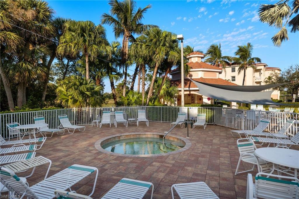 Image 3: View of pool featuring a hot tub and patio surround