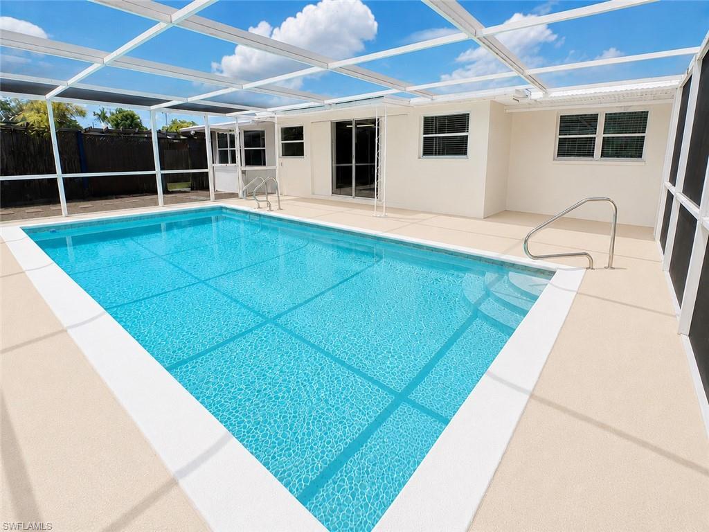 Image 2: Rectangular screened-in swimming pool with an integrated entry ladder and a full perimeter deck