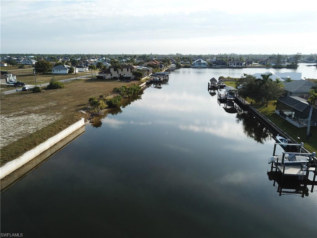 Image 2: Water view featuring a boat dock and nearby suburban area