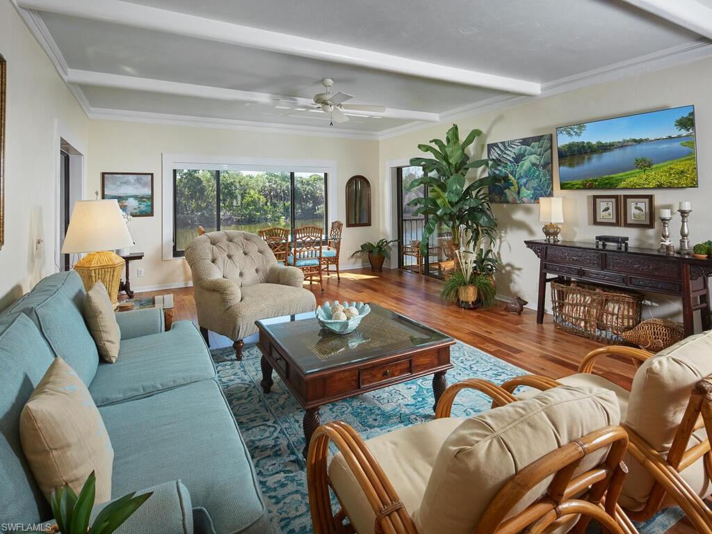 Image 4: Large living room with adjoining lanai overlooking the lake.