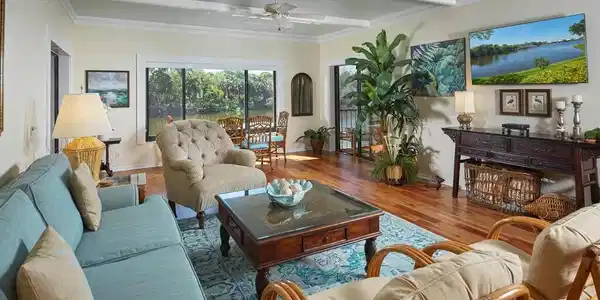 Image 4: Large living room with adjoining lanai overlooking the lake.