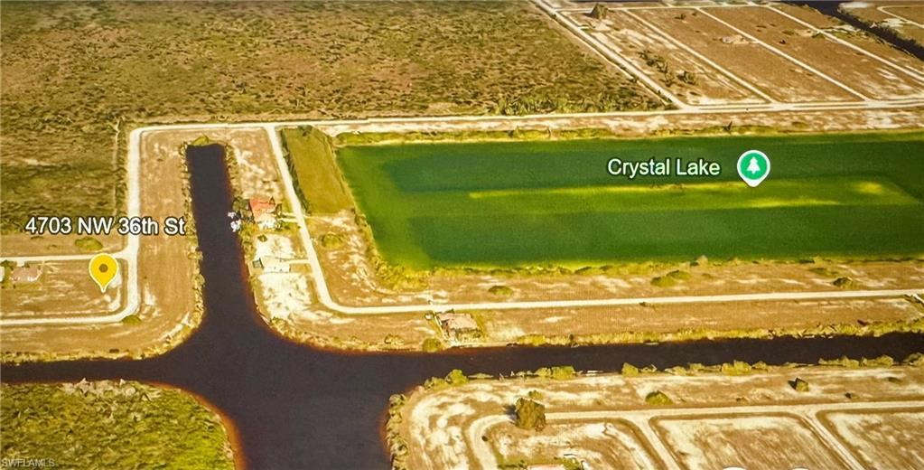 Image 1: Aerial perspective of suburban area with a large body of water