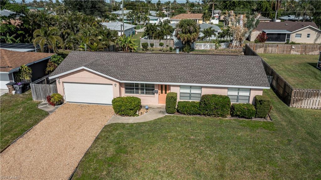 Image 1: Single story home with a garage and a front lawn