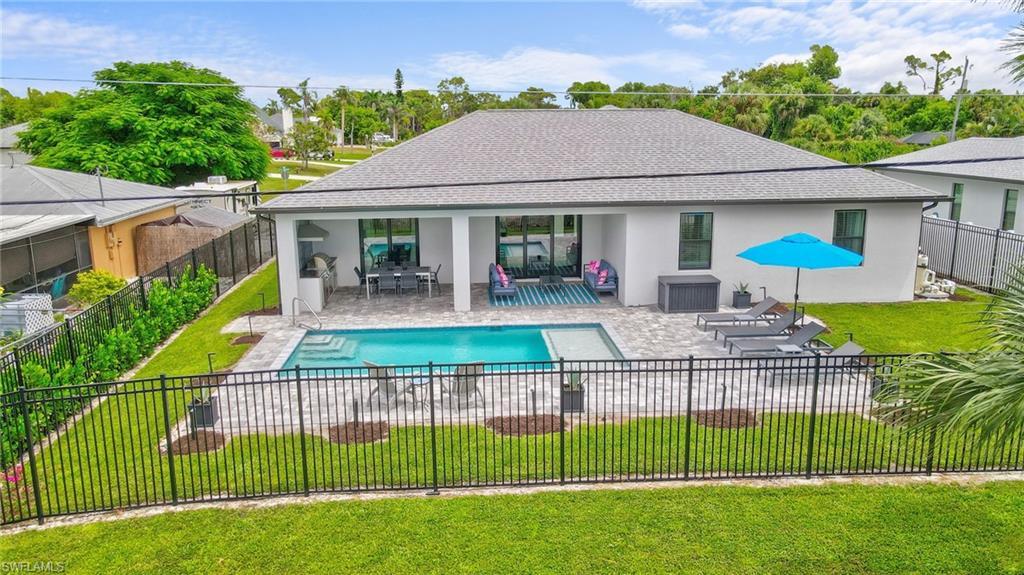 Image 3: View of swimming pool with a patio, a fenced backyard, and outdoor dining space