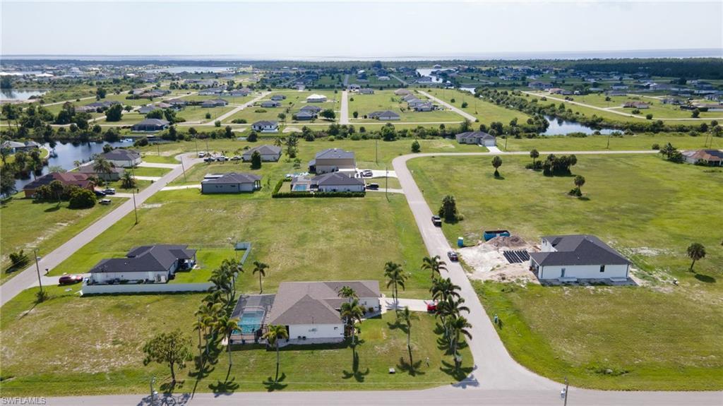 Image 2: Aerial perspective of suburban area with a nearby body of water