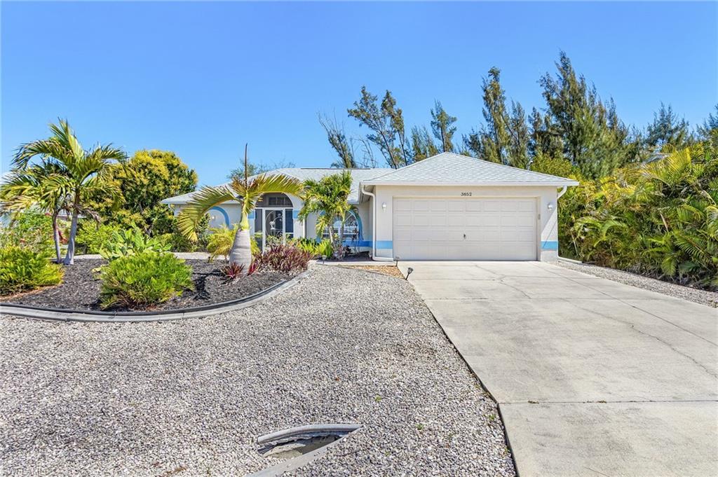 Image 2: Single story home with concrete driveway, an attached garage, and stucco siding