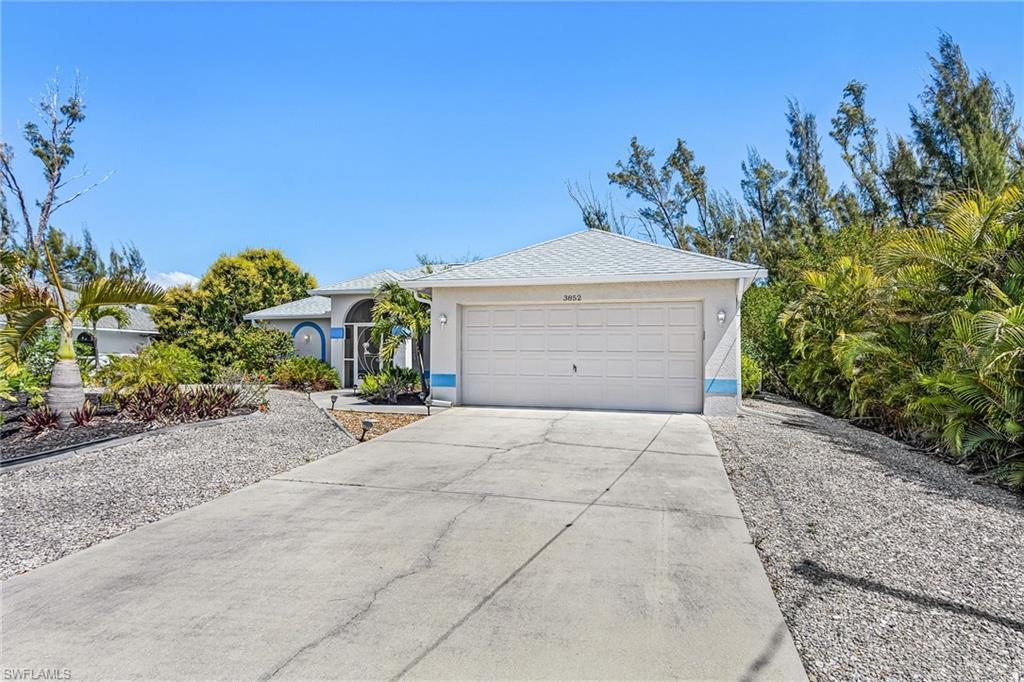 Image 3: View of front of home with concrete driveway, an attached garage, and stucco siding