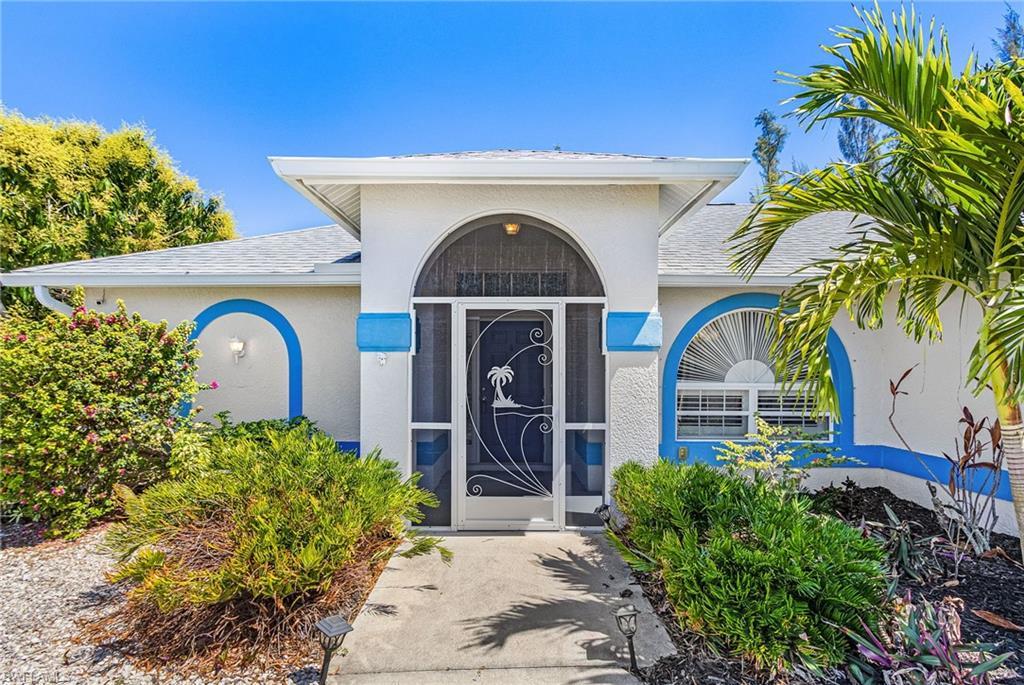Image 4: Doorway to property with roof with shingles and stucco siding