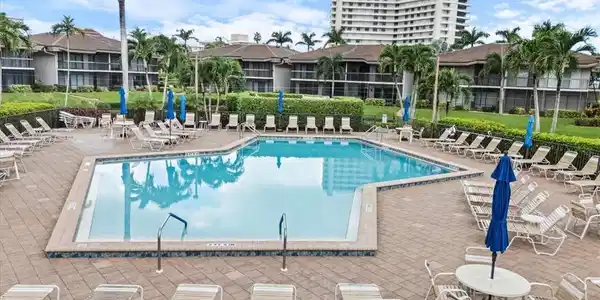 Image 4: Community pool featuring a patio area