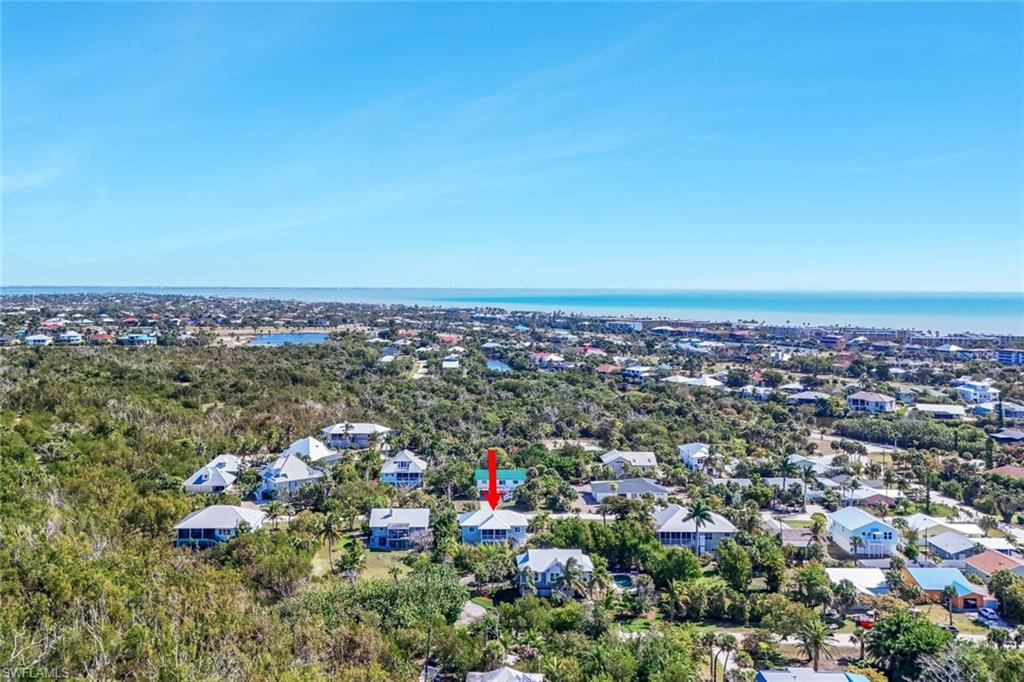 Image 2: Aerial perspective of suburban area featuring a nearby body of water