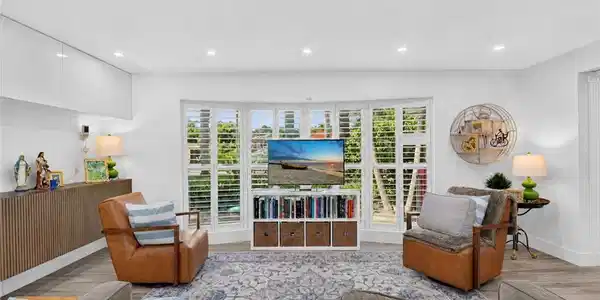 Image 4: Plantation shutters complement the windows.