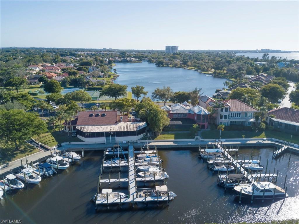 Image 1: Aerial perspective of suburban area with a large body of water