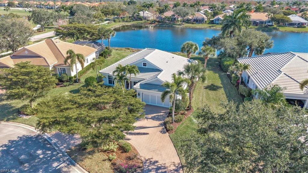 Image 2: Aerial perspective of suburban area with a nearby body of water