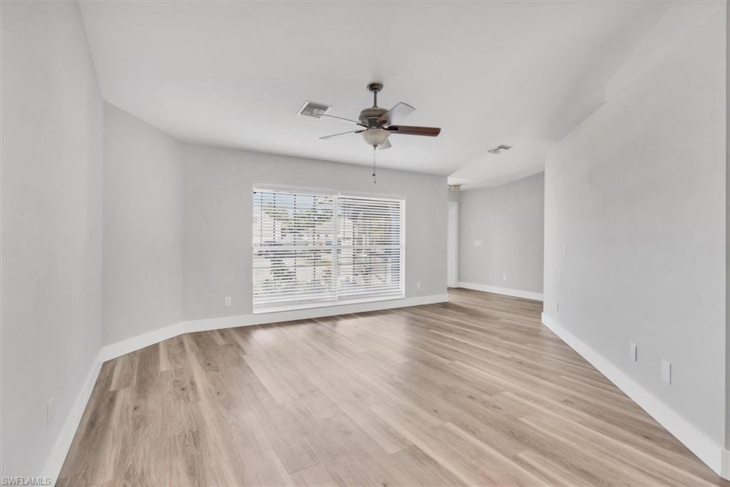 Image 4: Empty room featuring light wood-style floors and ceiling fan