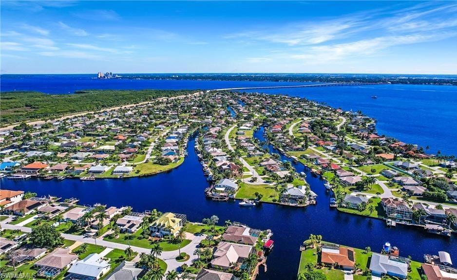 Image 2: Aerial perspective of suburban area with a large body of water