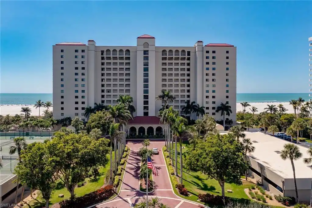 Image 1: View of building exterior with a view of the beach and a water view