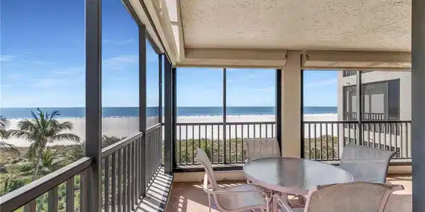 Image 2: Sunroom featuring a water view and a beach view
