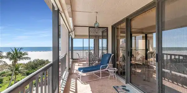Image 4: Balcony featuring a water view and a view of the beach