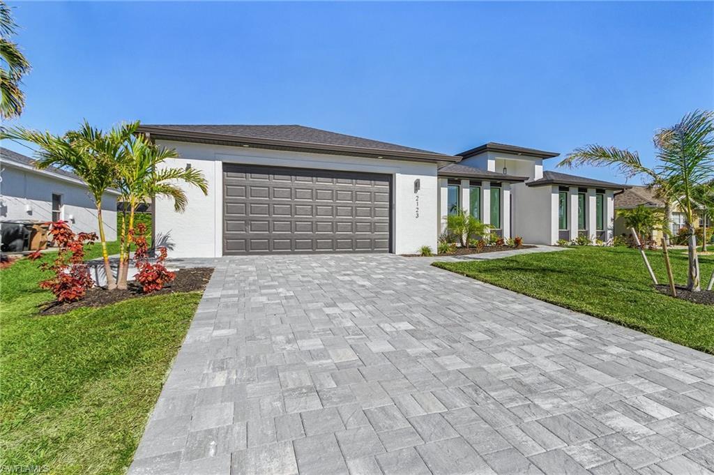 Image 4: View of front of house with a garage and a front lawn
