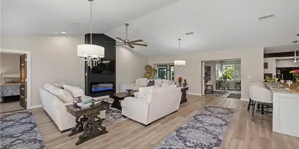 Image 3: looking into great room kitchen and extended lanai under air and entrance to the primary bedroom from foyer