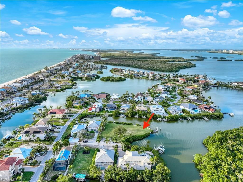 Image 4: Aerial view of property and surrounding area with nearby suburban area and a large body of water