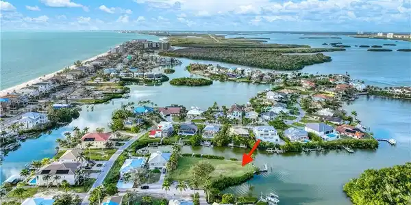 Image 4: Aerial view of property and surrounding area with nearby suburban area and a large body of water